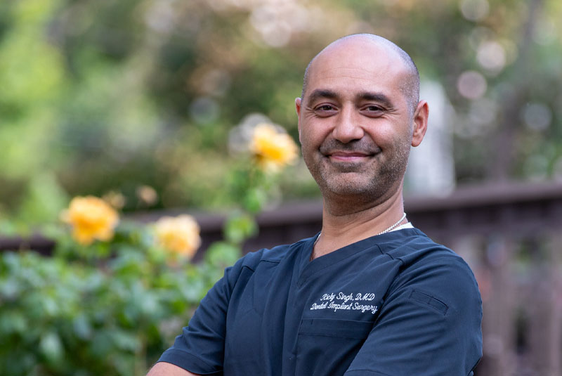 dr ricky singh outside practice near flowers