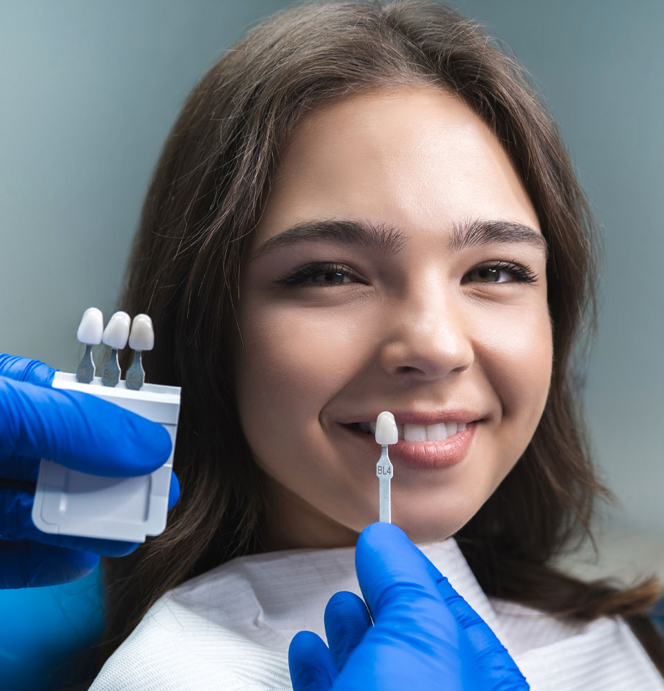 surgeon showing veneers to patient